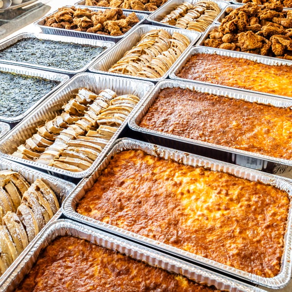 Catering trays of Southern Style Chicken & Waffle's fried chicken, waffles, and baked sides.